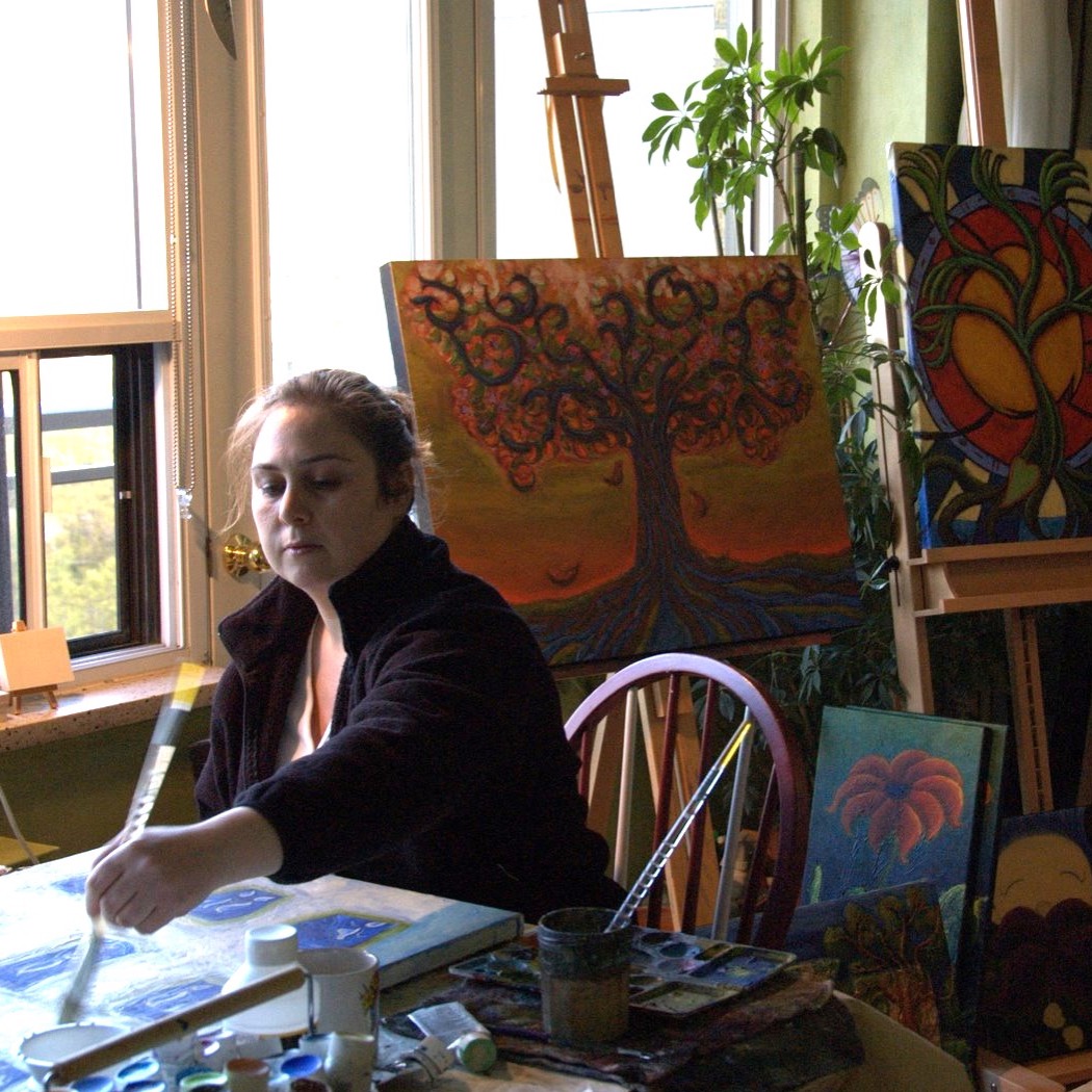 Melanie Sanchez painting in her studio
